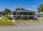Thumbnail 3 of 46 - A building with a parking lot in front of it.