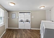 Thumbnail 17 of 46 - A laundry room with a washer and dryer.