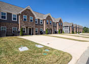 Thumbnail 4 of 29 - A row of houses with a clear blue sky above them.