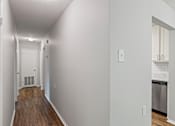 Thumbnail 30 of 46 - A long hallway with a door at the end.