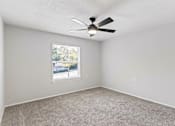 Thumbnail 41 of 46 - A room with a ceiling fan and a window.
