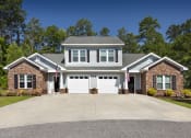 Thumbnail 1 of 50 - a house with a white garage door in front of a driveway
