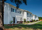 Thumbnail 4 of 46 - a white house with a tree in front of it
