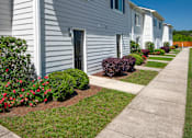 Thumbnail 6 of 46 - a white house with a sidewalk in front of it