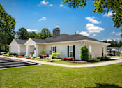 Thumbnail 22 of 43 - a white house with black shutters and a lawn and a driveway