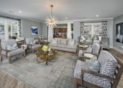 Thumbnail 27 of 50 - a living room with blue and white furniture and a chandelier