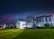 Thumbnail 5 of 36 - a row of houses on a green lawn at night