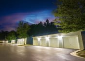 Thumbnail 11 of 36 - a garage with white doors at night under a purple sky