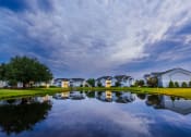 Thumbnail 2 of 36 - a body of water in front of a row of houses