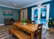 Thumbnail 16 of 36 - a dining room with a wooden table and chairs     and a pool