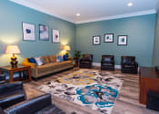 Thumbnail 21 of 36 - a living room with a couch and chairs and a rug