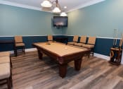 Thumbnail 23 of 36 - a game room with a pool table and a tv