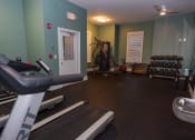 Thumbnail 18 of 36 - a gym with treadmills and other exercise equipment