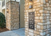 Thumbnail 5 of 91 - A sign on a stone pillar indicates the building number and the number of floors.