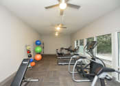 Thumbnail 12 of 39 - Apartments For Rent In Vestavia Hills, AL - MarQ Vestavia - Fitness Center With Exercise Balls, Large Windows, Ceiling Fans, Workout Bench, Treadmills, And Elliptical Machine