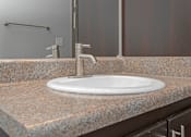 Thumbnail 74 of 91 - A bathroom sink with a white plate on it.