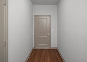 Thumbnail 59 of 91 - A room with a wooden floor and a white door.