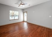 Thumbnail 61 of 91 - A room with a ceiling fan and wooden flooring.