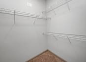Thumbnail 75 of 91 - Empty room with white walls and shelving.