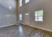 Thumbnail 31 of 47 - A room with wooden flooring and a white door.