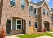 Thumbnail 4 of 13 - a large brick house with a wooden door