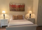 Thumbnail 43 of 47 - A bedroom with a large bed and two lamps.