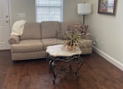 Thumbnail 37 of 47 - A living room with a couch and a table.