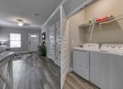 Thumbnail 23 of 47 - A laundry room with a washer and dryer.