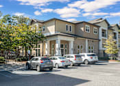 Thumbnail 31 of 91 - A row of cars are parked in front of a building.