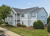 Thumbnail 2 of 35 - A two-story house with a grey exterior and blue trim.