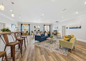 Thumbnail 18 of 35 - A living room with a blue couch and yellow armchair.