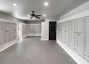Thumbnail 18 of 46 - a locker room with lockers and a ceiling fan