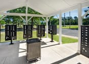 Thumbnail 20 of 43 - a group of servers in a pavilion with trees in the background