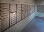 Thumbnail 35 of 91 - A row of mailboxes are lined up on a wall.