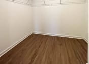Thumbnail 10 of 13 - an empty bedroom with white walls and wood floors