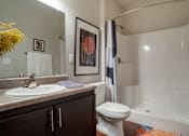 Thumbnail 90 of 91 - A bathroom with a toilet, sink, and bathtub.