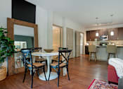Thumbnail 81 of 91 - A dining room with a white table and chairs.