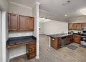 Thumbnail 41 of 50 - a kitchen and living room with wood floors and wooden cabinets