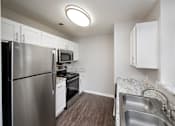 Thumbnail 36 of 43 - a kitchen with stainless steel appliances and granite counter tops