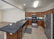 Thumbnail 38 of 50 - a large kitchen with stainless steel appliances and wood cabinets