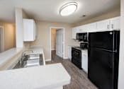 Thumbnail 37 of 43 - a kitchen with white cabinets and a black refrigerator