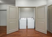Thumbnail 57 of 91 - Two washing machines are in a laundry room.