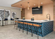 Thumbnail 25 of 91 - A modern bar with a wooden ceiling and a flat screen TV mounted on the wall.