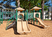 Thumbnail 18 of 43 - a playground with slides and swings in front of a house