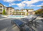 Thumbnail 8 of 91 - A sunny day at the outdoor pool area of a residential complex.