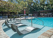 Thumbnail 11 of 91 - A pool with a red flag and lounge chairs.