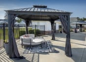 Thumbnail 14 of 50 - a patio with a couch and a gazebo