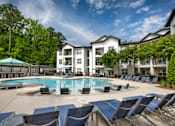 Thumbnail 15 of 57 - A large white building with a pool in front.
