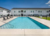 Thumbnail 28 of 46 - our apartments have a resort style pool with chairs and umbrellas
