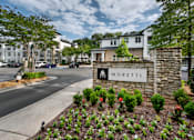 Thumbnail 9 of 57 - A street view of Moretti apartments with a stone entrance sign.